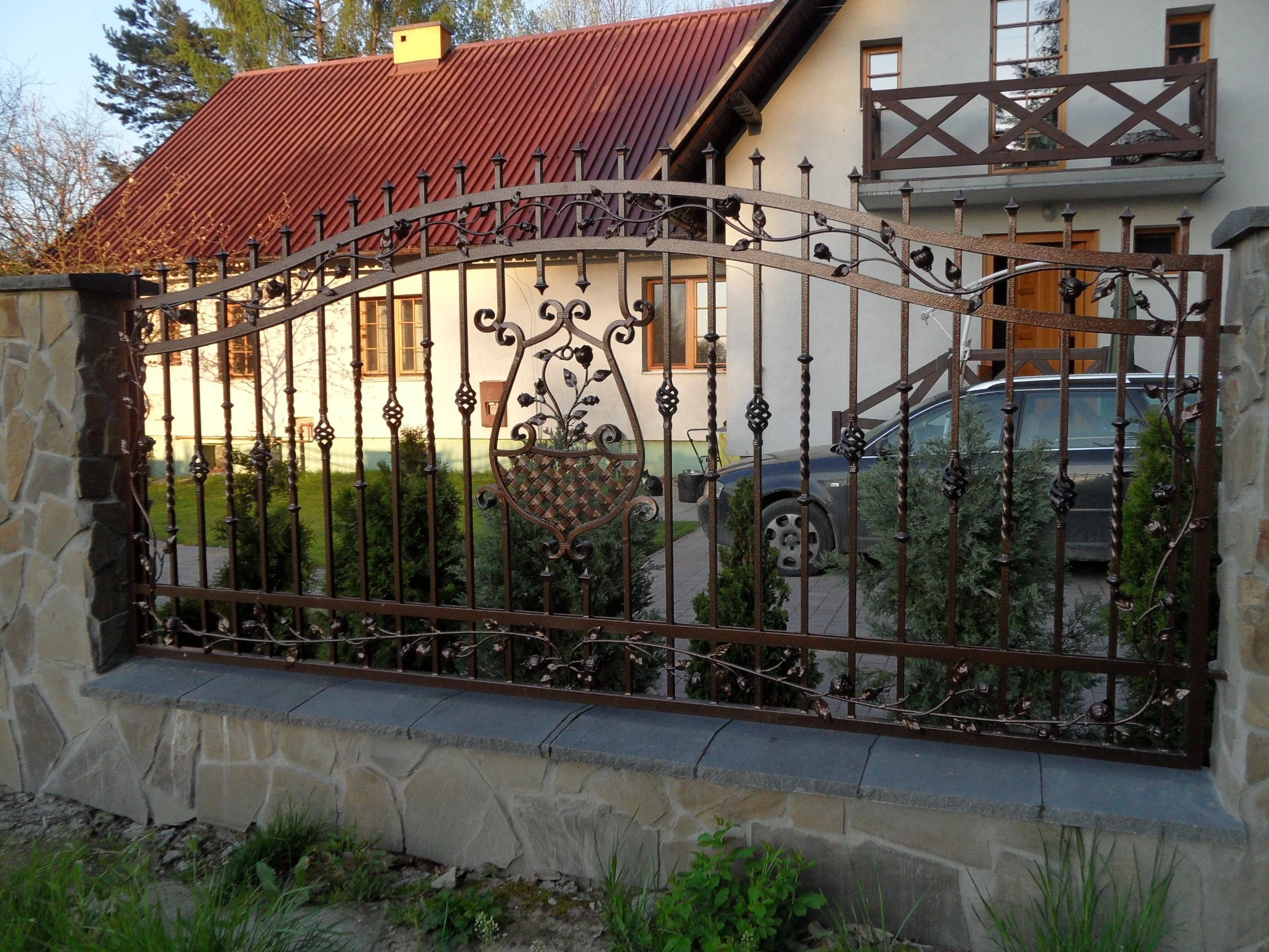 Ozdobne ogrodzenie kute - motyw kosza z kwiatami